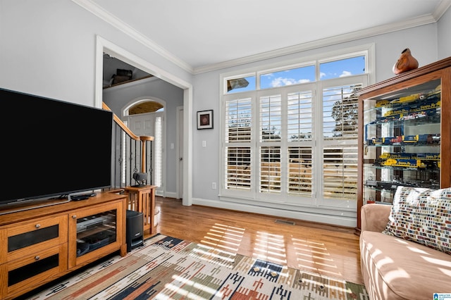 living room featuring light wood-type flooring and ornamental molding