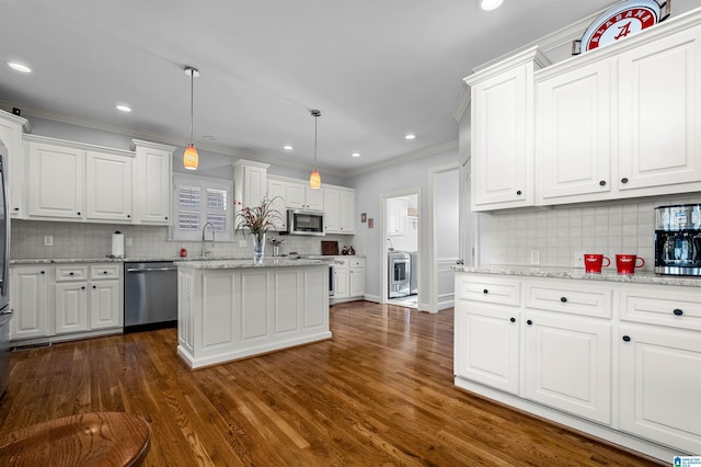 kitchen with dark hardwood / wood-style flooring, light stone counters, stainless steel appliances, white cabinetry, and hanging light fixtures