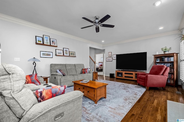 living room with ceiling fan, dark wood-type flooring, and ornamental molding