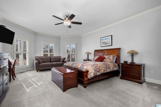 carpeted bedroom featuring ceiling fan and crown molding