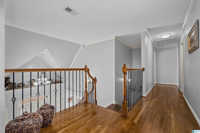 corridor with hardwood / wood-style floors and crown molding