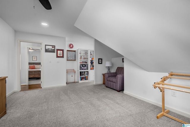 sitting room featuring carpet flooring, ceiling fan, and vaulted ceiling