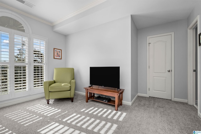 sitting room with crown molding and light carpet