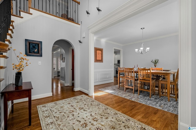 dining room featuring a chandelier, ornamental molding, and dark wood-type flooring