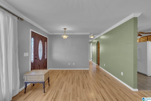 foyer entrance with light hardwood / wood-style floors and crown molding