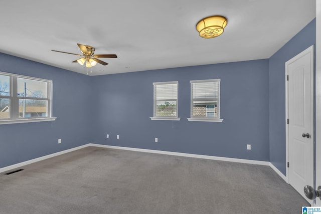 spare room featuring ceiling fan and carpet floors