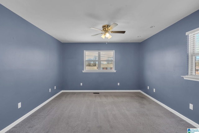 carpeted empty room featuring ceiling fan