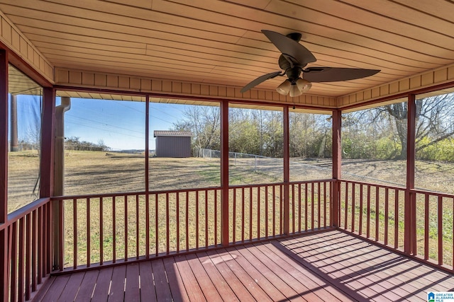 unfurnished sunroom with plenty of natural light, ceiling fan, and wood ceiling