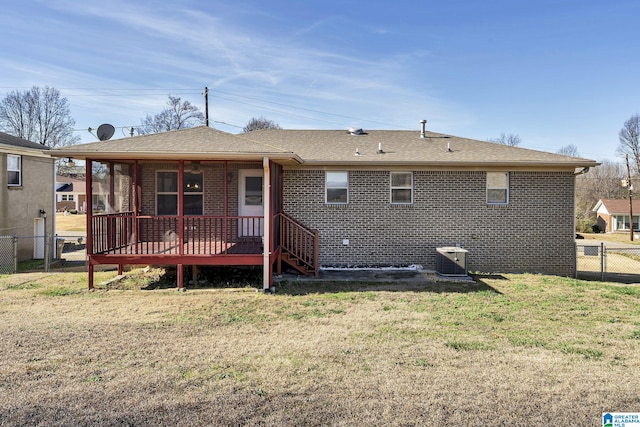 back of house with a lawn, cooling unit, and a deck