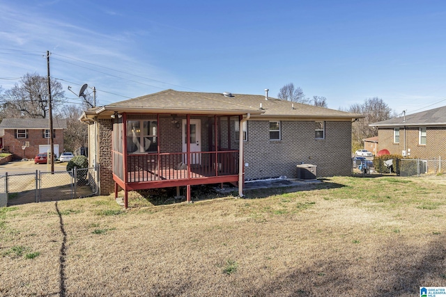 rear view of house with a lawn and cooling unit