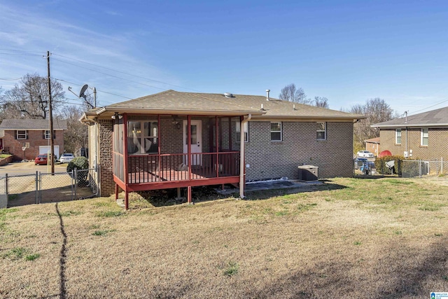 back of property with central AC unit and a lawn