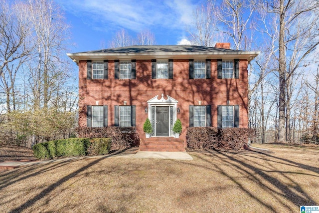 colonial-style house with a front lawn