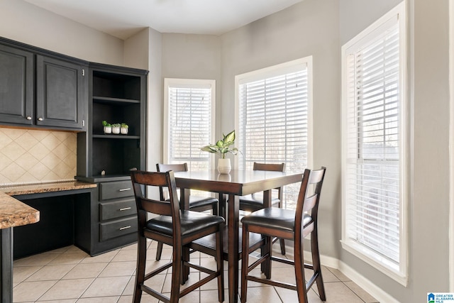 dining space featuring light tile patterned floors