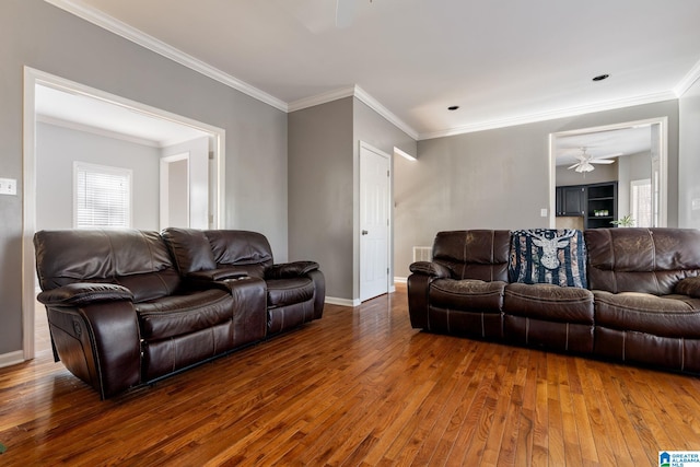 living room with dark hardwood / wood-style floors, ceiling fan, and crown molding