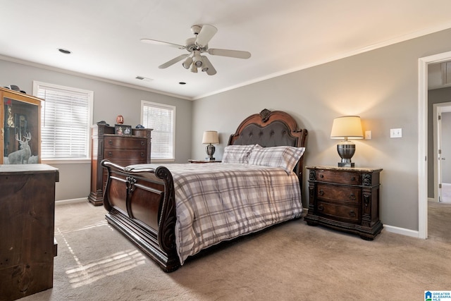 carpeted bedroom with ceiling fan and ornamental molding