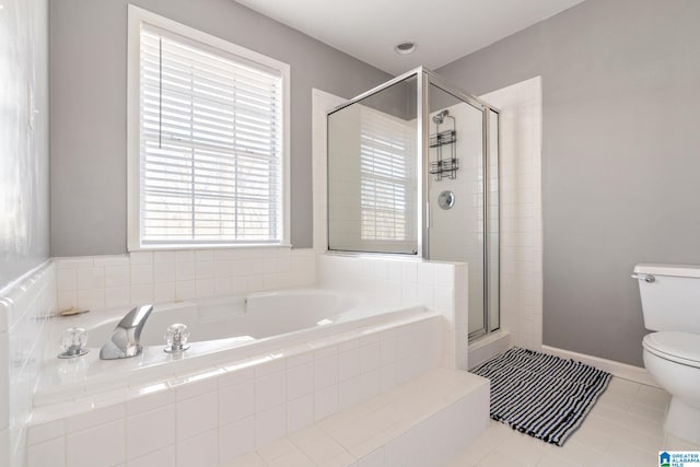 bathroom featuring tile patterned flooring, toilet, and independent shower and bath