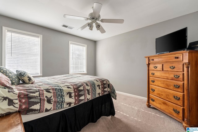 bedroom featuring light carpet and ceiling fan