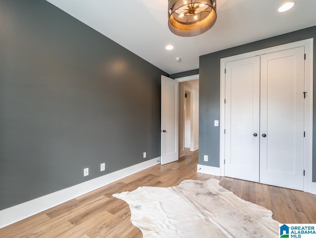 bedroom with light wood-type flooring and a closet