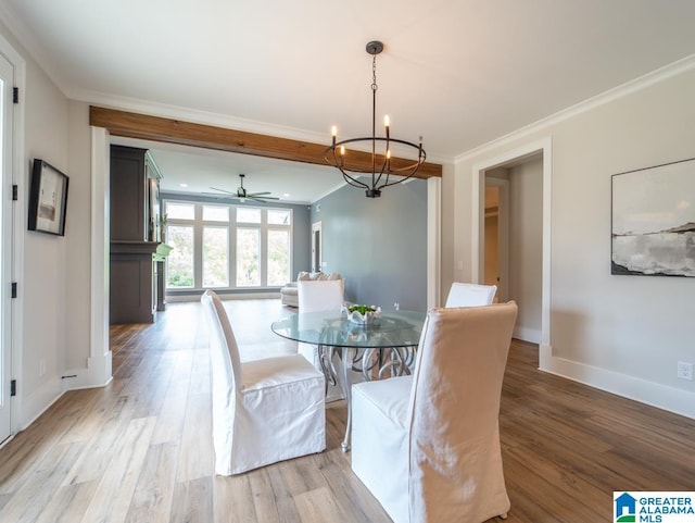 dining area featuring ceiling fan with notable chandelier, light wood-type flooring, and ornamental molding