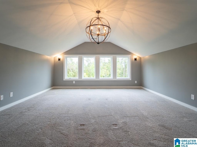 additional living space featuring lofted ceiling, light carpet, and an inviting chandelier