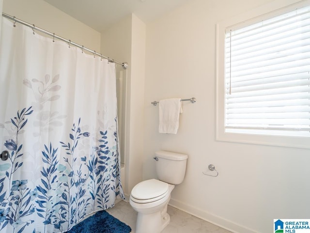 bathroom with tile patterned flooring and toilet