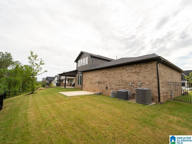 back of house featuring a patio area, central air condition unit, and a yard