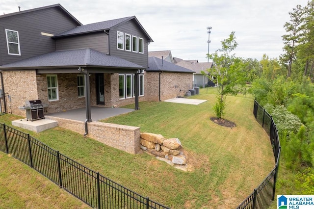 rear view of house featuring a patio, cooling unit, and a lawn