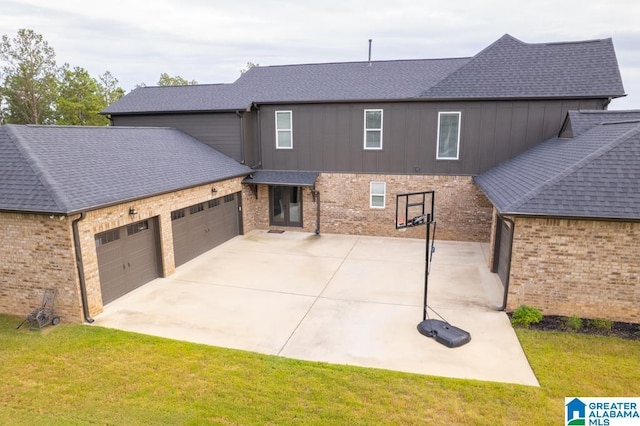 exterior space featuring a lawn and a garage