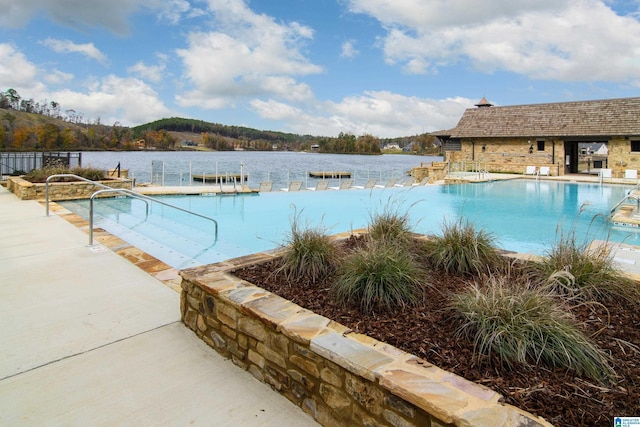 view of pool with a water view