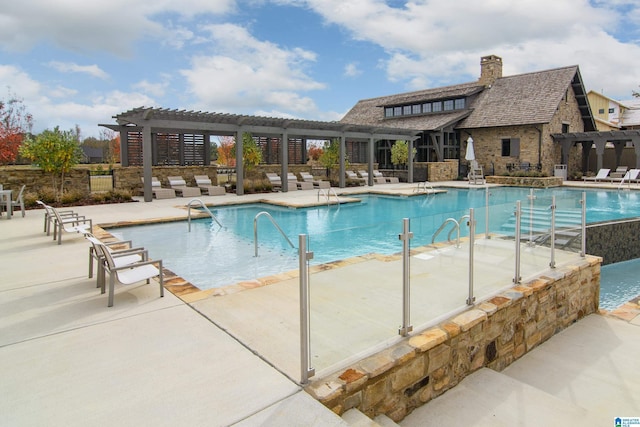 view of pool with a pergola and a patio area