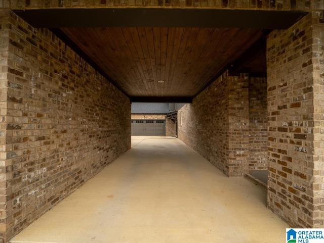 basement with wood ceiling and brick wall