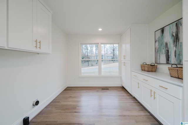 laundry room featuring light hardwood / wood-style flooring