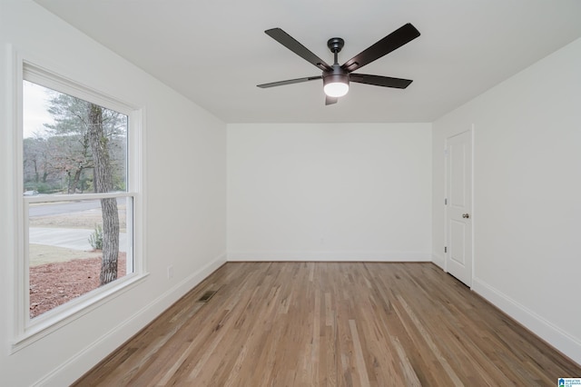 unfurnished room with light hardwood / wood-style flooring and ceiling fan