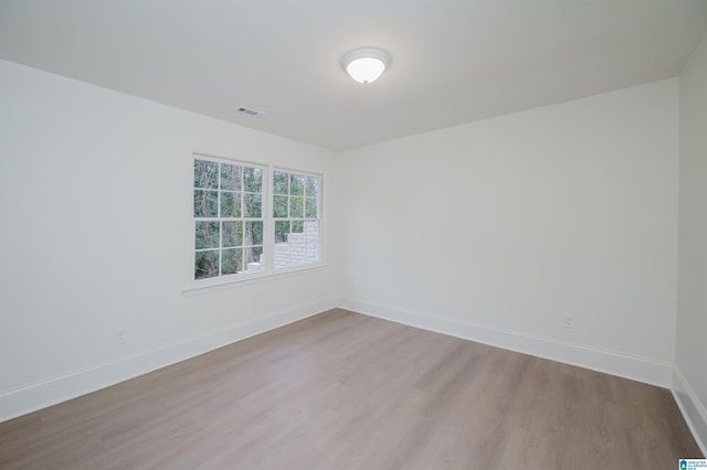 unfurnished room with light hardwood / wood-style floors