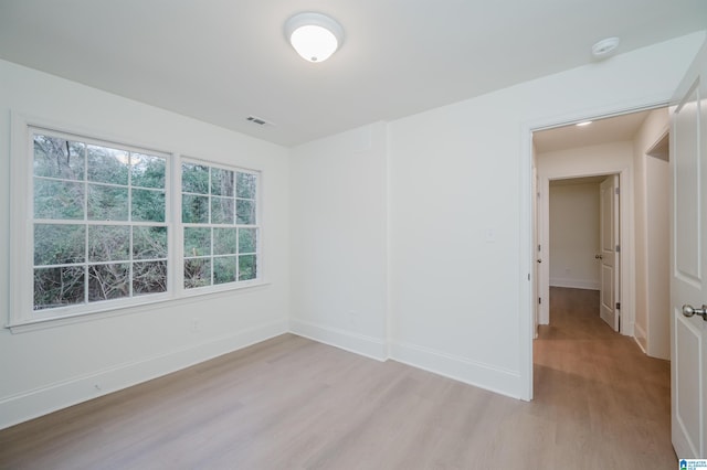 spare room featuring light wood-type flooring