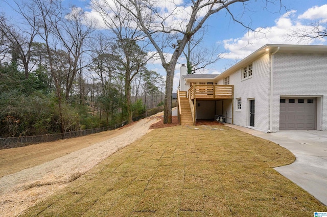 view of side of property featuring a garage and a deck