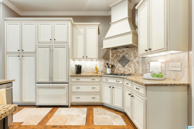 kitchen with tasteful backsplash, crown molding, and custom exhaust hood