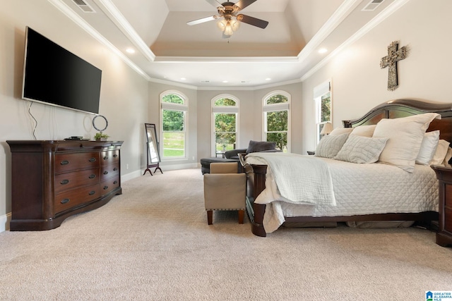 carpeted bedroom featuring a raised ceiling, ceiling fan, and crown molding