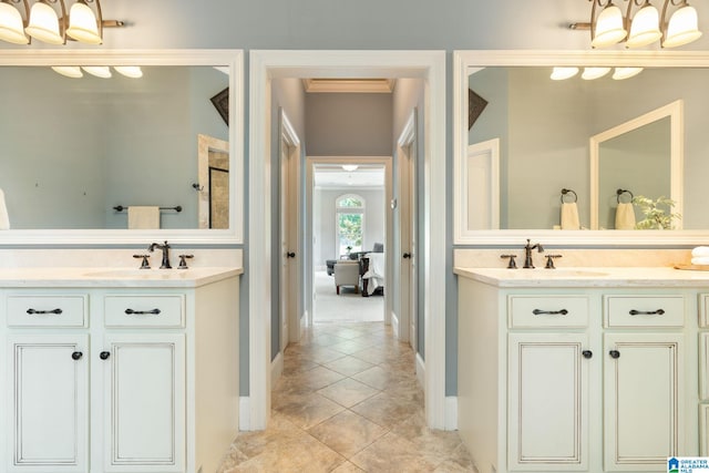 bathroom with tile patterned flooring, vanity, and walk in shower