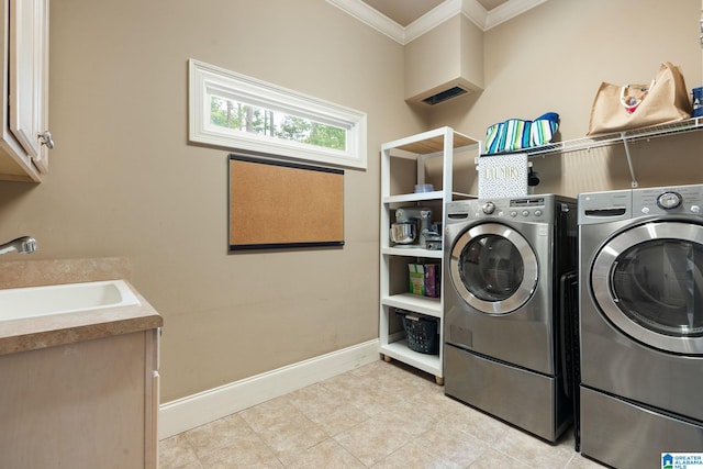 washroom featuring washer and dryer, cabinets, sink, and crown molding