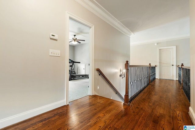 hall with hardwood / wood-style floors and crown molding