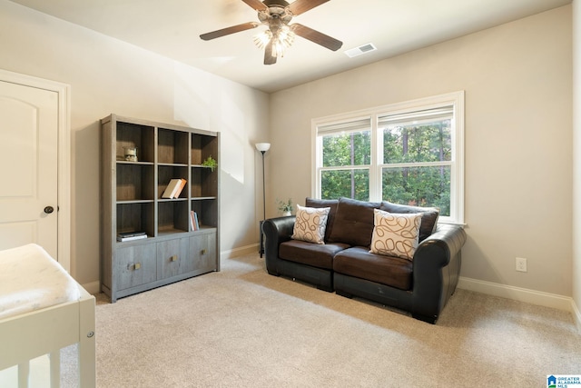 living room featuring light carpet and ceiling fan