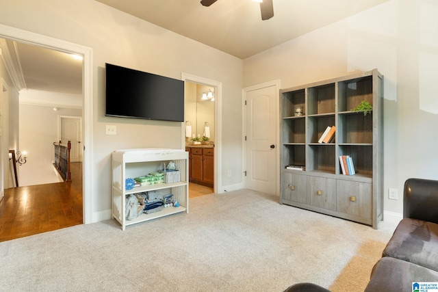 carpeted living room with ceiling fan