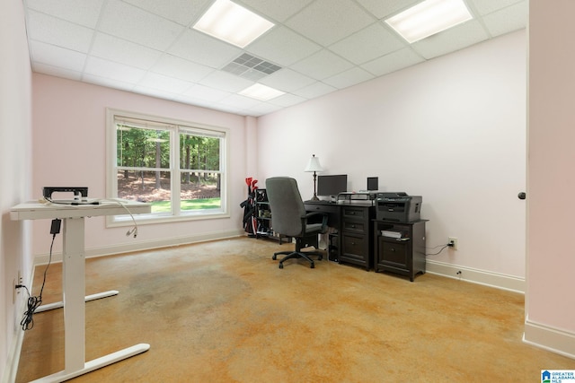 home office featuring a paneled ceiling and light carpet