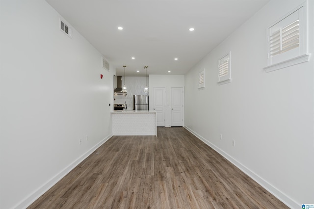 unfurnished living room with hardwood / wood-style floors