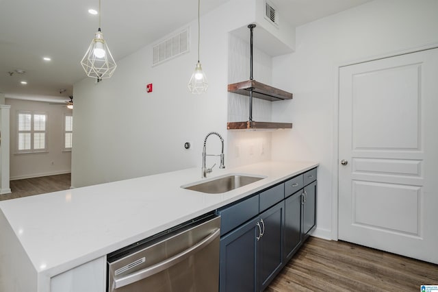 kitchen featuring ceiling fan, sink, stainless steel dishwasher, kitchen peninsula, and pendant lighting