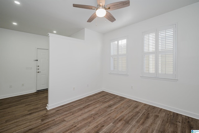 empty room featuring ceiling fan and dark wood-type flooring