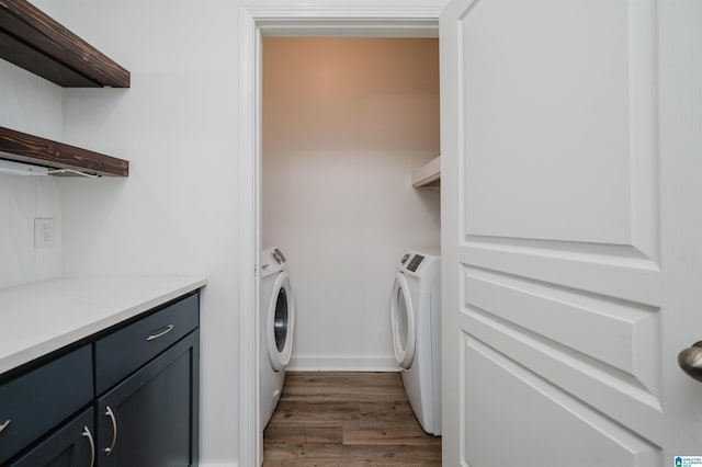 laundry area with washer and clothes dryer and dark hardwood / wood-style floors