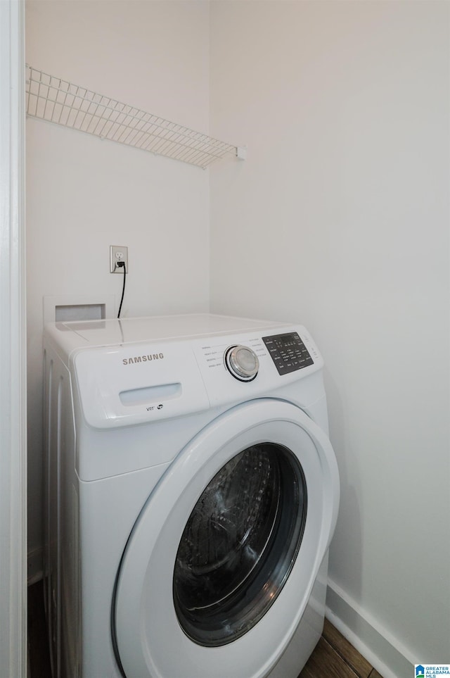 laundry room with dark wood-type flooring and hookup for a washing machine