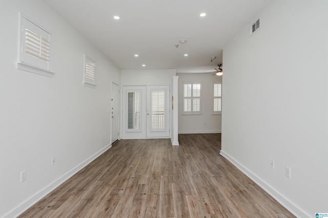 interior space with ceiling fan, light hardwood / wood-style flooring, and french doors